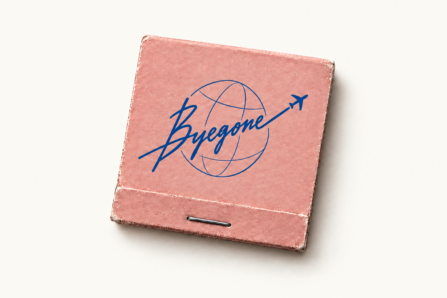 A vintage pink matchbook with the blue Byegone globe and airplane logo
